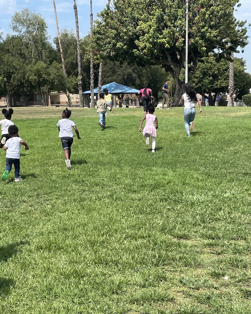 Children are running through the park during playtime.